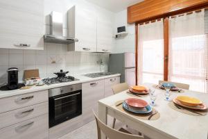 a kitchen with a table with plates on it at Station House Center in Cisterna di Latina