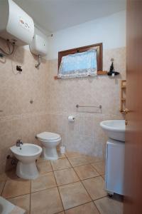 a bathroom with a toilet and a sink at Residenza Su Prelau in Gonnesa +40 photos