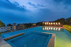 a swimming pool at a resort at night at Hotel Seagull in Digha