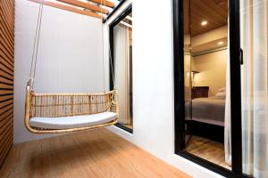 a swing in a room with a bed and a mirror at Boutique hotel Axis Bangkok in Bangkok