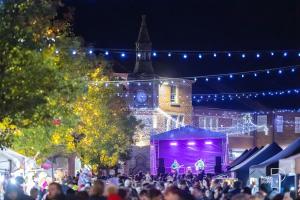 a crowd of people in front of a building with lights at Spacious Ormskirk Contractor Stay by PolkaStays in Ormskirk
