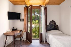 a bedroom with a bed and a desk and a television at Villa Trigona in Piazza Armerina +75 photos