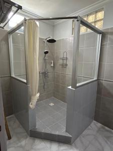 a shower with a glass door in a bathroom at Villa Pelangi - Candidasa in Candidasa +18 photos