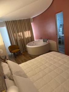 a bedroom with a large tub in a room at Masseria Brigarè in Cassano delle Murge
