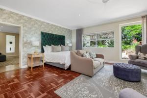 a bedroom with a bed and a living room at Manor On Main in Midrand +28 photos