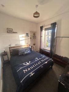 a bedroom with a bed and a window and a bed sidx sidx sidx at 'Nautical Nook' -Island Escape in Millport
