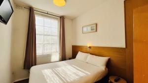 Llit o llits en una habitació de Arriva Hotel