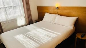 Llit o llits en una habitació de Arriva Hotel