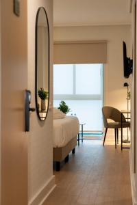 a bedroom with a bed and a mirror at Villa Augusta Spa & Garden in Valladolid