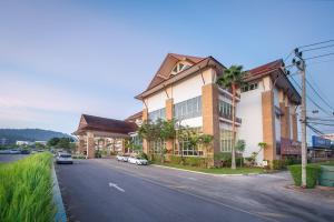 a building with cars parked on the side of a street at Kaewsamui Resort in Ban Tha Phet Noi