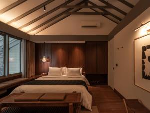 a bedroom with a large bed and a large window at Brown Feather Pererenan in Canggu +13 photos