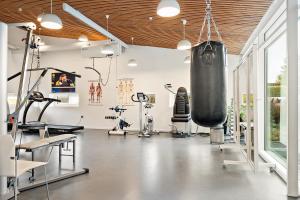 a fitness room with a gym with exercise equipment at Musholm Holiday, Sport & Conference in Korsør