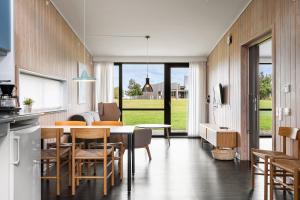 a kitchen and dining room with a table and chairs at Musholm Holiday, Sport & Conference in Korsør