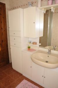 a white bathroom with a sink and a mirror at Cascina tra le vecchie vigne con piscina in Canale +34 photos