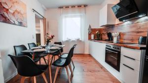 a dining room with a table and chairs in a kitchen at FlexHome Stilvolle Ferienwohnung in Lippstadt