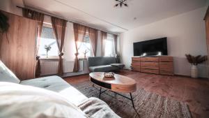 a living room with a couch and a coffee table at FlexHome Stilvolle Ferienwohnung in Lippstadt