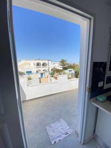 a door to a room with a view of a building at Maison a midoun in Midoun +3 photos