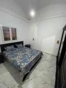 a bedroom with a bed in a white room at Maison a midoun in Midoun