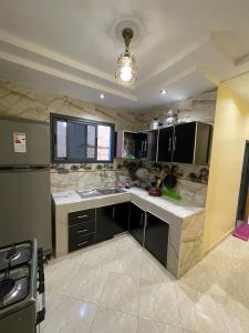 a kitchen with a sink and a counter top at Waves Surf House in Taghazout