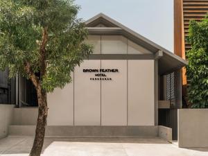 a building with a sign on the side of it at Brown Feather Pererenan in Canggu