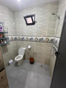 a bathroom with a toilet and a shower at Waves Surf House in Taghazout +15 photos
