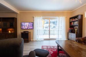 a living room with a couch and a tv at Spacious Apartment - City Center in Stryn +41 photos