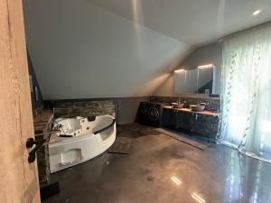 a large bathroom with a tub and a sink at Traumhaus in der Eifel in Hellenthal +43 photos
