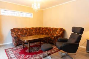 a living room with a couch and two chairs at Spacious Apartment - City Center in Stryn