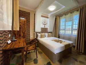 a hotel room with a bed and a window at Mawimbi Jiko Hotel in Taveta +36 photos