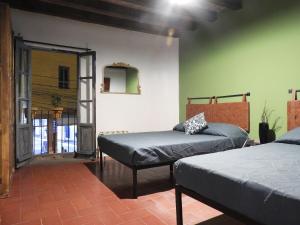 a bedroom with two beds and a mirror at Doña Vicenta Casa Colonial in Guanajuato