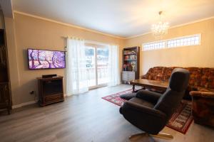 a living room with a couch and a table at Spacious Apartment - City Center in Stryn