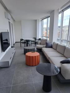 a living room with couches and tables and windows at SAIFI Apartments in Beirut