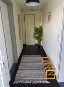 a hallway with a rug and a door with a plant at Le Stein in Steinbach