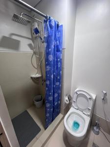 a small bathroom with a toilet and a shower at Iloilo Condo Sm City Style Residences in Iloilo City