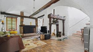 a living room with a couch and a fireplace at Old Mill in Pigna