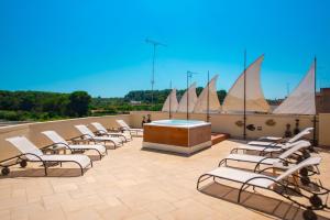 a group of chairs sitting on top of a roof at Corte Di Nettuno - CDSHotels in Otranto