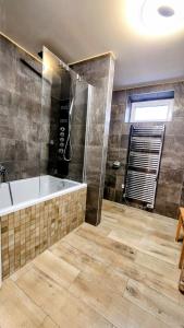 a large bathroom with a tub and a shower at Ubytko 151 Broumov in Broumov +10 photos