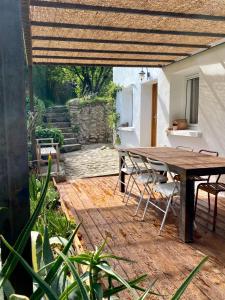 a wooden table and chairs on a patio at La maison de Juliette in Céret