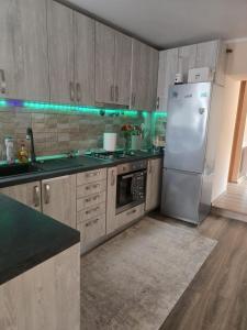 a kitchen with a stainless steel refrigerator and counters at Casa Izabella in Tîrnăveni