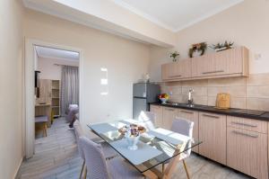 a kitchen and dining room with a table and chairs at Potamos Apartments in Sidari +48 photos