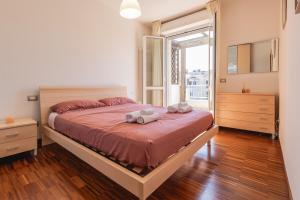 a bedroom with a large bed with two towels on it at Angelic Darsena Apartment in Ravenna