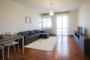 a living room with a couch and a table at Angelic Darsena Apartment in Ravenna