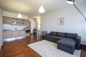 a living room with a couch and a kitchen at Angelic Darsena Apartment in Ravenna