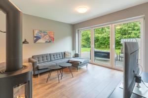 a living room with a couch and a fireplace at Risum Huus in Risum-Lindholm