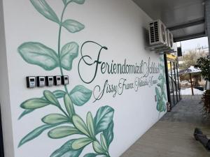 a mural of a plant on the side of a building at Ferienwohnung Sophia in Bad Gleichenberg