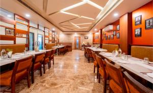 a dining room with long tables and chairs at HHW Hotel- Agra in Agra