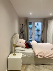 a bedroom with a bed and a window at Brand New One Bedroom Apartment in Hendon