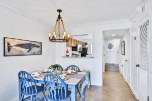 a dining room with a blue table and chairs at Summerhouse 147 condo in St. Augustine
