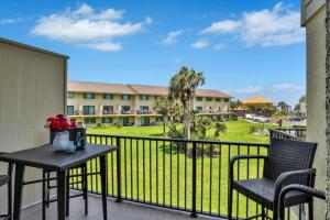 a balcony with a table and chairs and a view of a park at Summerhouse 147 condo in St. Augustine +28 photos