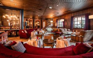 a restaurant with tables and chairs in a room at Chalets LA MOURRA in Val-d'Isère